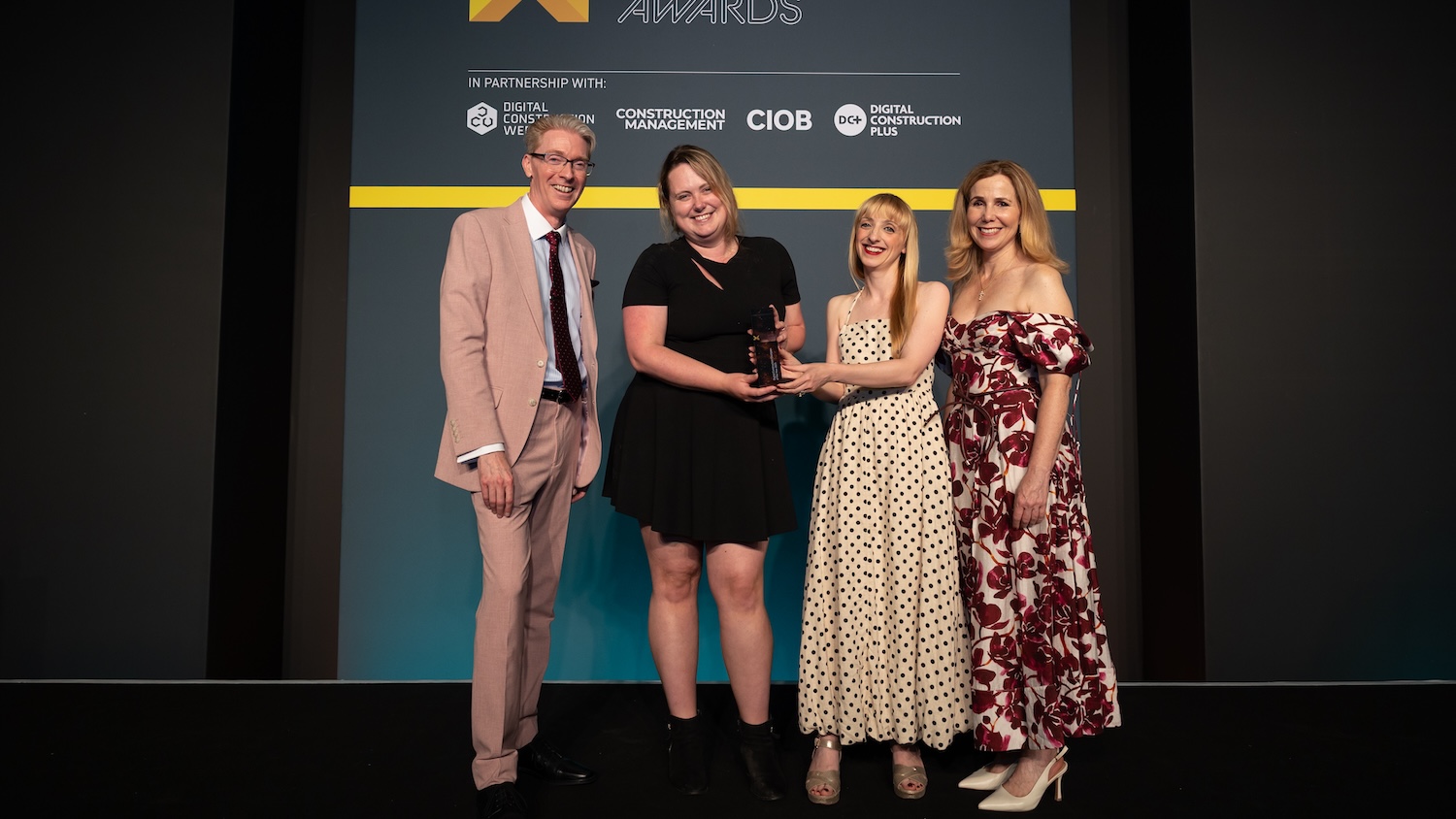 Dr Melanie Robinson collects her trophy for Digital Construction Champion of the Year at the Digital Construction Awards 2025