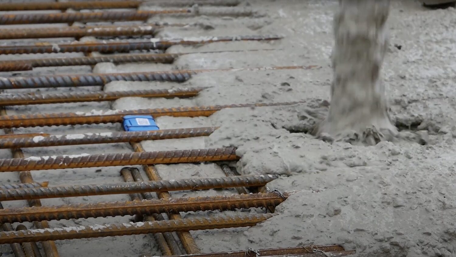Concrete being poured with a Tarmac CEVO Digital maturity sensor in place