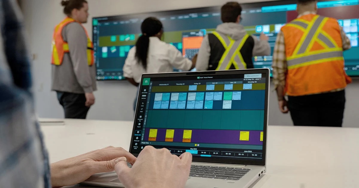 Photo the Nialli planner system being used on a screen and laptop